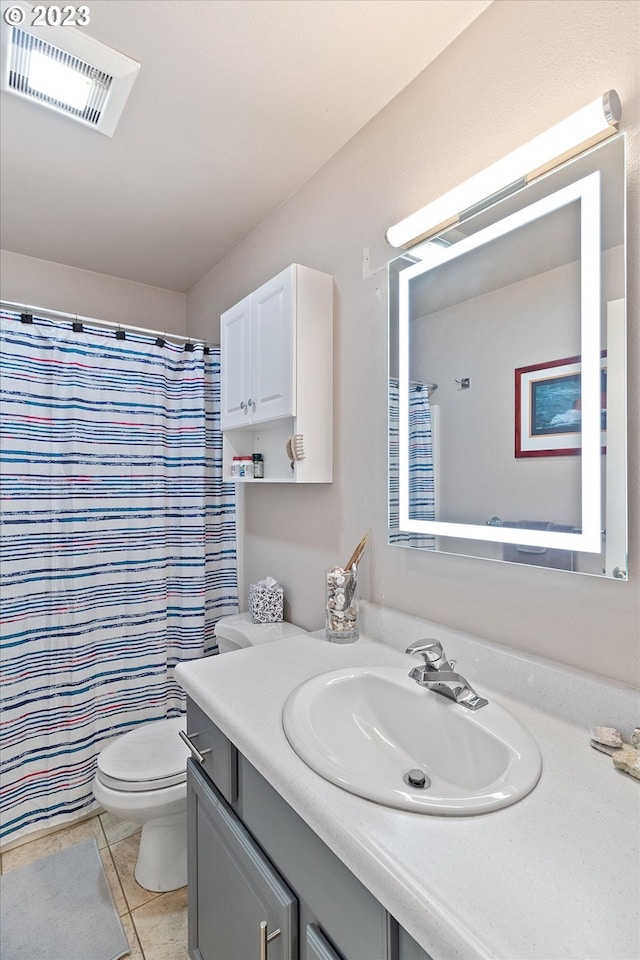 bathroom with vanity, a shower with curtain, tile patterned floors, and toilet