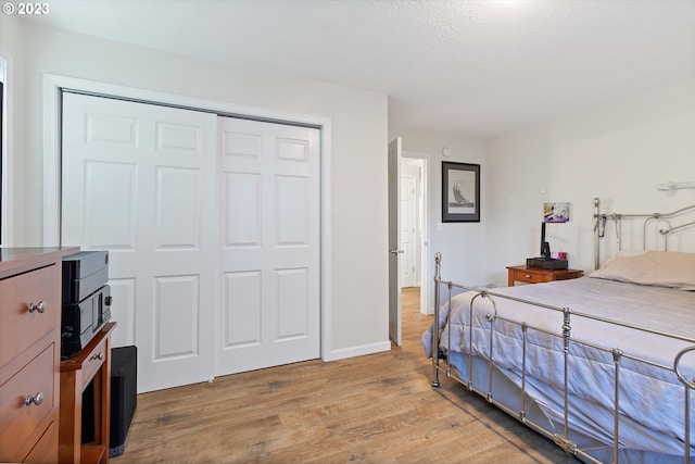 bedroom featuring light hardwood / wood-style floors and a closet