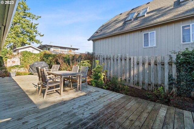 wooden terrace with a grill