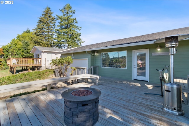 deck featuring an outdoor fire pit