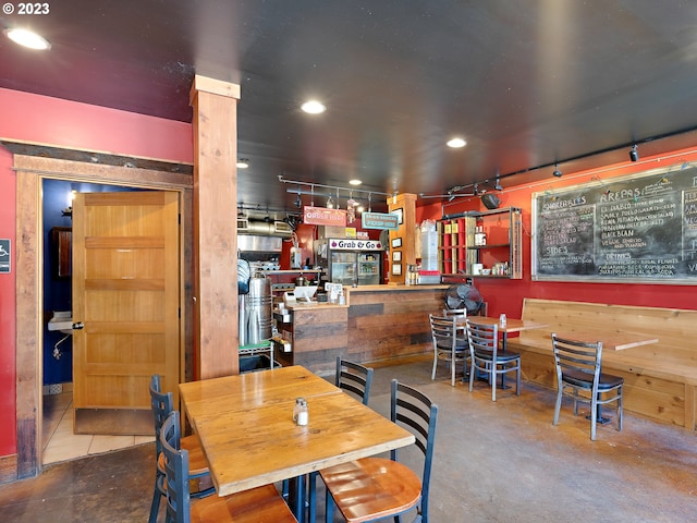 dining room with bar and concrete floors