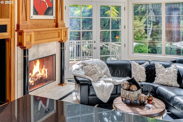 sunroom / solarium with french doors, a tile fireplace, and a healthy amount of sunlight