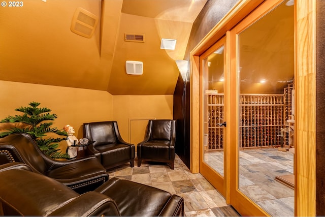 interior space with light tile floors and lofted ceiling