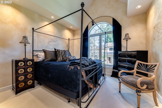 carpeted bedroom with a high ceiling