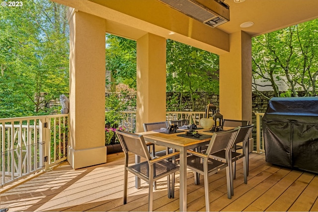 wooden terrace with a grill