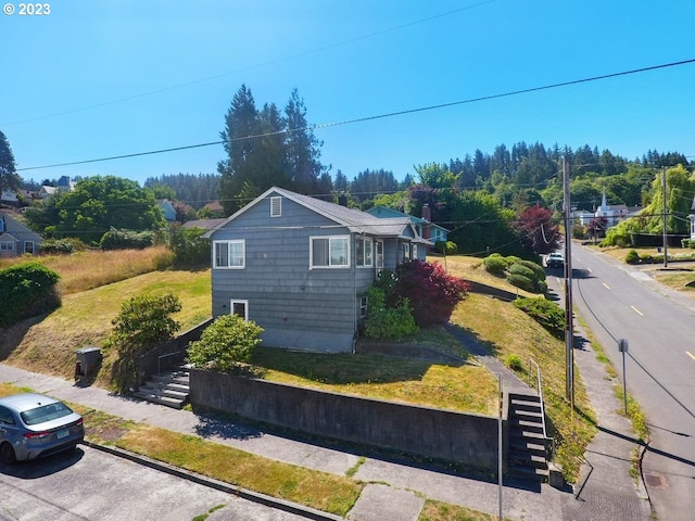 view of side of home with a lawn