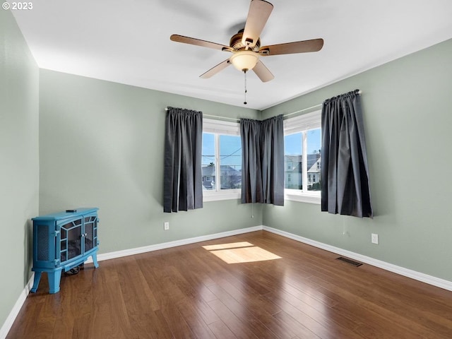 unfurnished room featuring ceiling fan and dark hardwood / wood-style floors