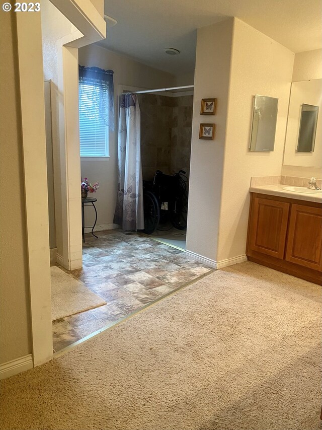 bathroom with tile flooring and large vanity