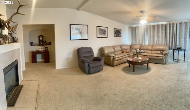 carpeted living room with ceiling fan and vaulted ceiling with beams