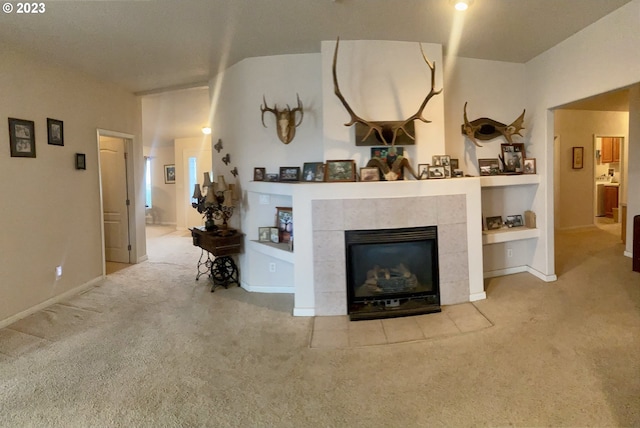 carpeted living room with built in features and a fireplace