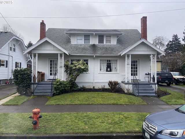 bungalow-style house with a front yard