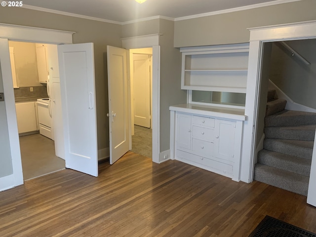 interior space featuring ornamental molding and dark hardwood / wood-style floors