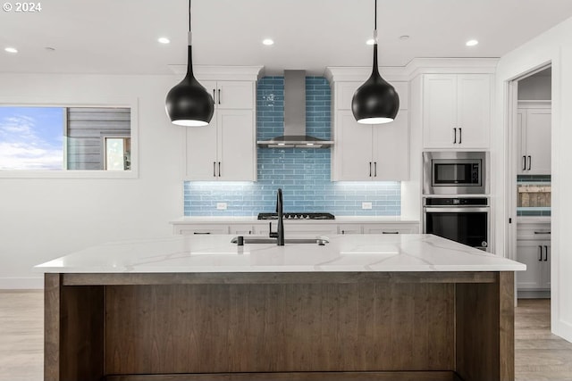 17007 NE 82nd St, Vancouver, WA 98682 - kitchen featuring stainless steel appliances, tasteful backsplash, light wood-style flooring, and wall chimney range hood