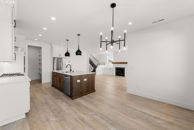 17007 NE 82nd St, Vancouver, WA 98682 - kitchen with a glass covered fireplace, appliances with stainless steel finishes, open floor plan, and light countertops