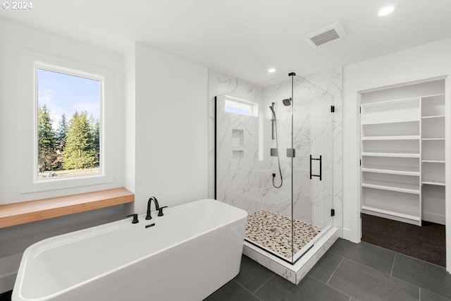 bathroom with independent shower and bath, plenty of natural light, and tile patterned flooring