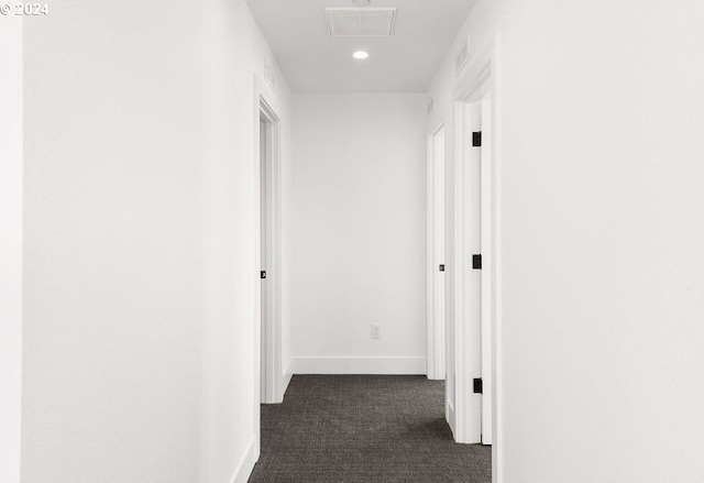 corridor with dark colored carpet