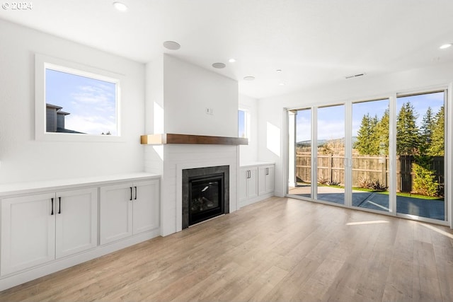 17007 NE 82nd St, Vancouver, WA 98682 - unfurnished living room with a glass covered fireplace, visible vents, light wood-style flooring, and recessed lighting