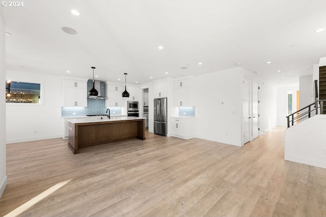 17007 NE 82nd St, Vancouver, WA 98682 - kitchen featuring open floor plan, appliances with stainless steel finishes, light countertops, and wall chimney range hood