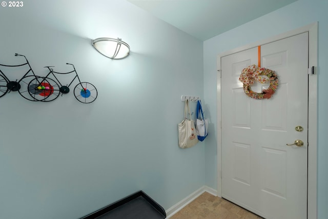 entryway with light colored carpet