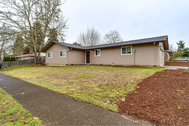 ranch-style home with fence and a front lawn