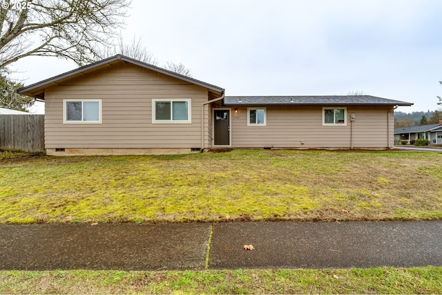 ranch-style home featuring a front yard and fence