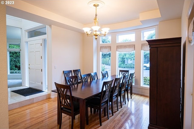 dining area featuring an inviting chandelier and light wood-type flooring