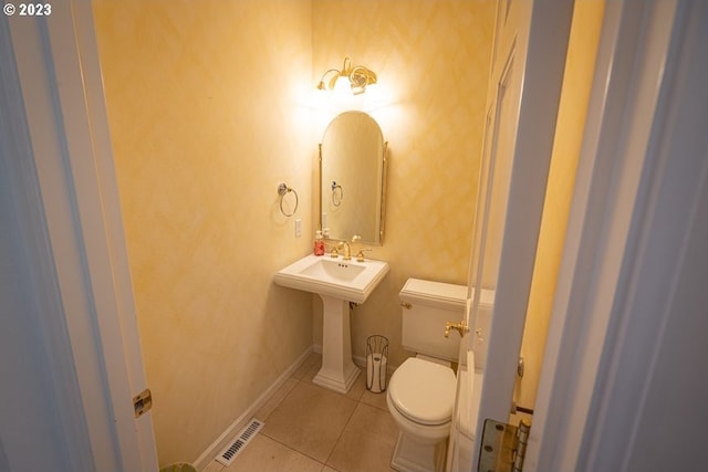 bathroom with toilet and tile patterned flooring