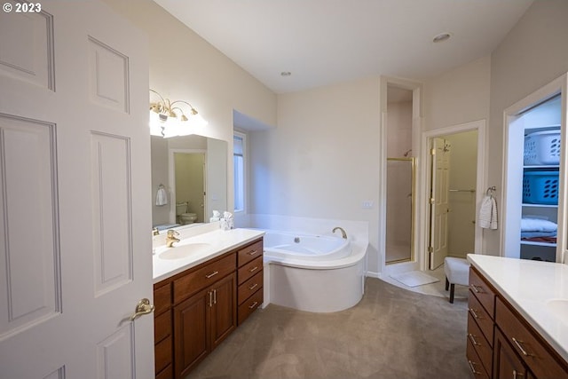 bathroom featuring vanity and shower with separate bathtub