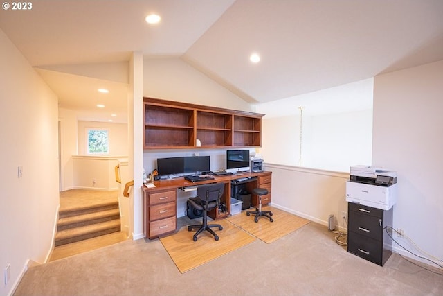 carpeted home office featuring vaulted ceiling