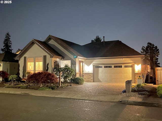 ranch-style house featuring a garage, stucco siding, concrete driveway, and stone siding