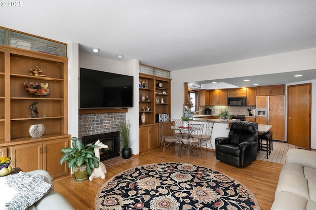 living area featuring a fireplace and light wood-style floors