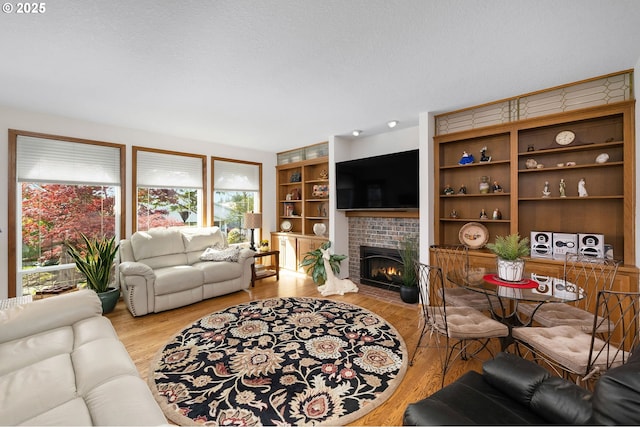 2037 NE 158th Pl, Portland, OR 97230 - living area featuring plenty of natural light, a fireplace, and light wood-type flooring