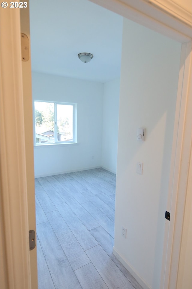 unfurnished room featuring light wood-style flooring