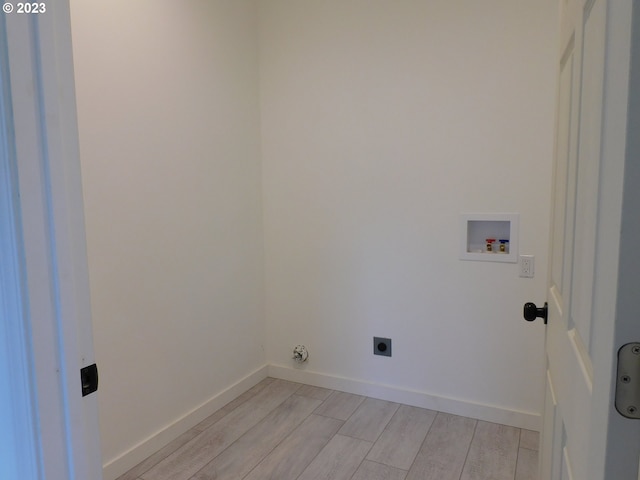 laundry area with washer hookup, wood finish floors, hookup for an electric dryer, laundry area, and baseboards