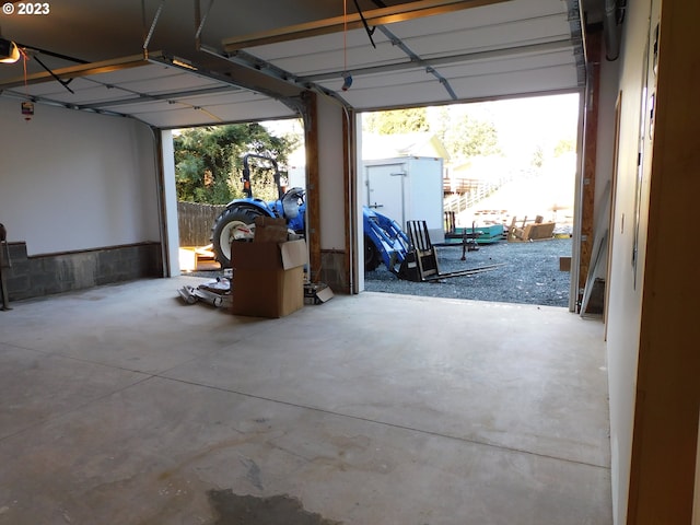 garage featuring a storage shed and a garage door opener