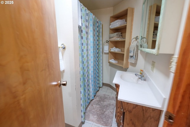 full bath with tile patterned floors, vanity, and curtained shower
