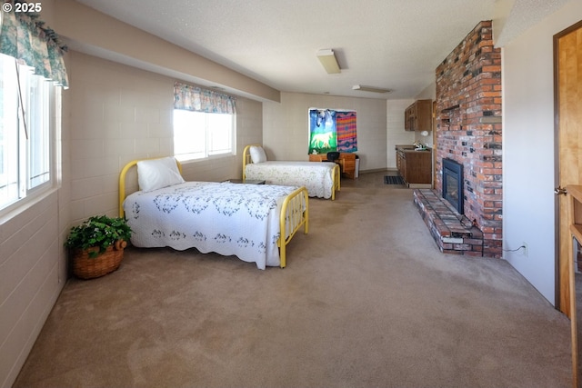 bedroom featuring a brick fireplace and light carpet