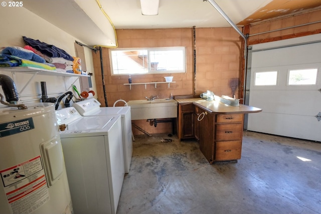 clothes washing area featuring laundry area, a sink, washer and clothes dryer, and electric water heater