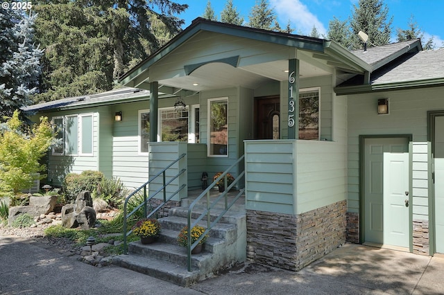 view of front of property with covered porch and roof with shingles