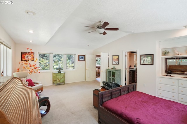 bedroom featuring lofted ceiling, a ceiling fan, carpet floors, and a textured ceiling