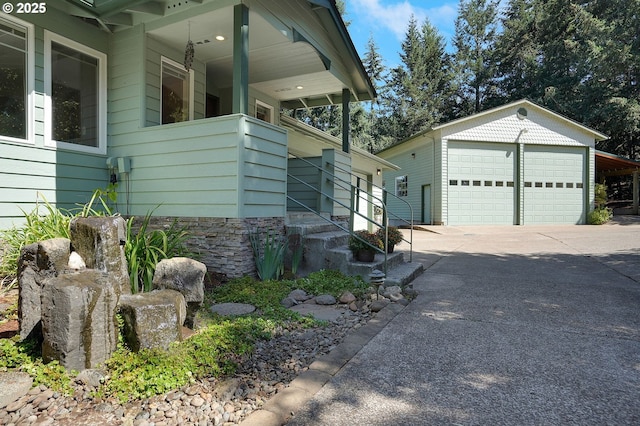 view of home's exterior featuring a garage and an outbuilding