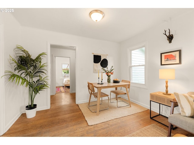 office space featuring baseboards and wood finished floors