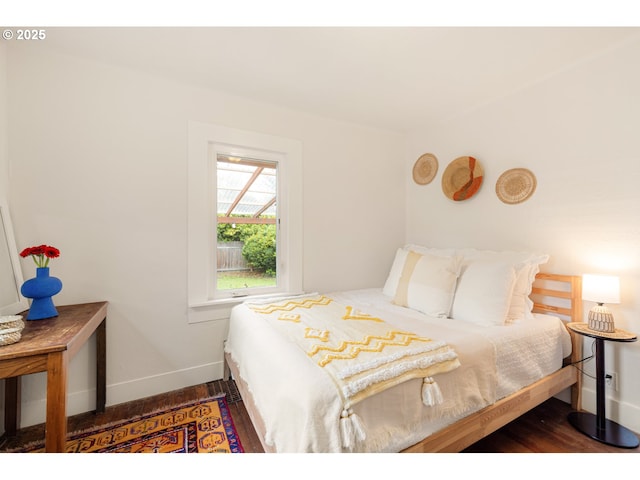 bedroom featuring baseboards and wood finished floors