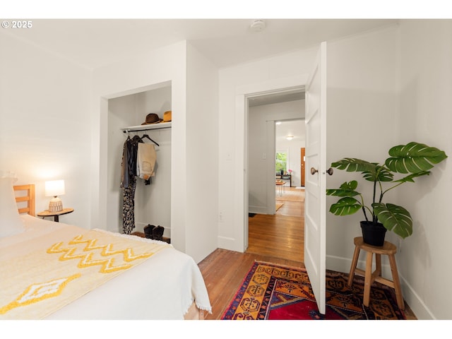 bedroom with a closet and wood finished floors