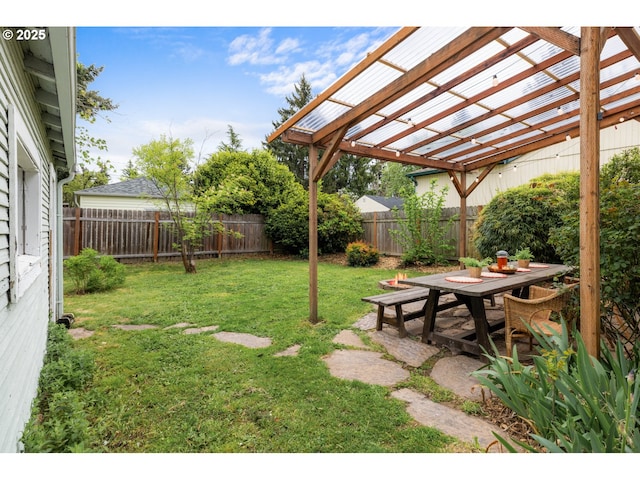 view of yard featuring outdoor dining area, a fenced backyard, and a pergola
