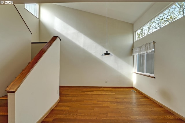 interior space with baseboards and wood finished floors
