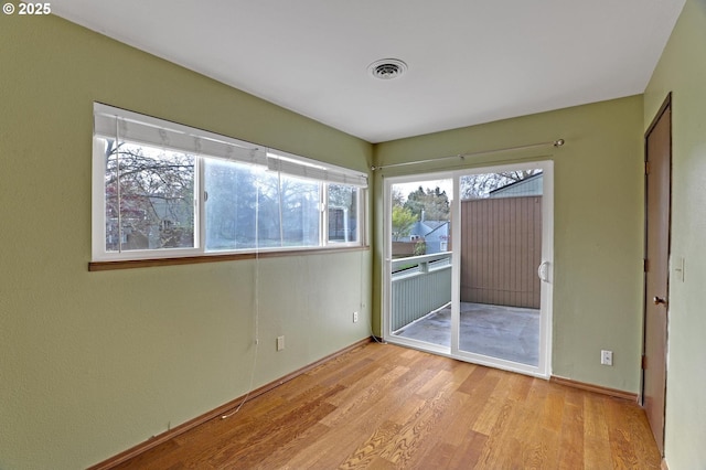 unfurnished bedroom featuring light wood-type flooring, baseboards, and visible vents