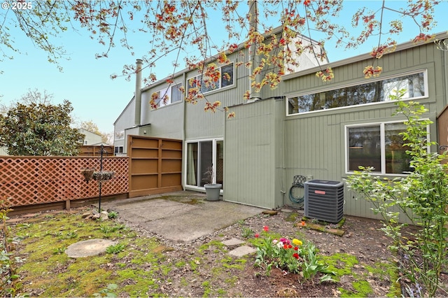 back of property with a patio, cooling unit, and fence