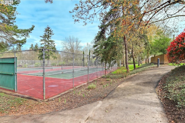 view of tennis court featuring fence