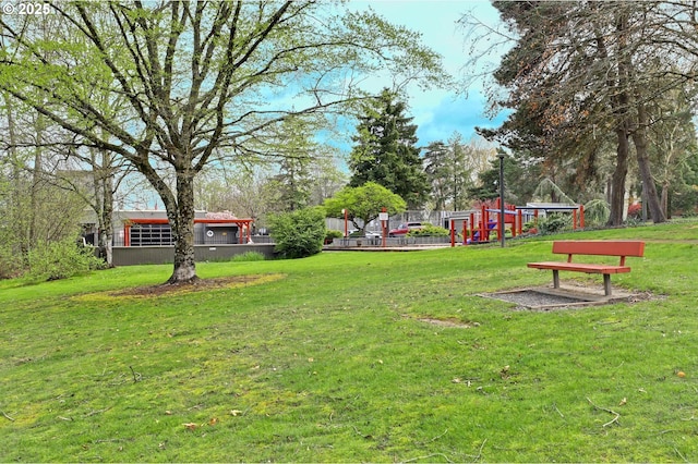 surrounding community with a yard and playground community